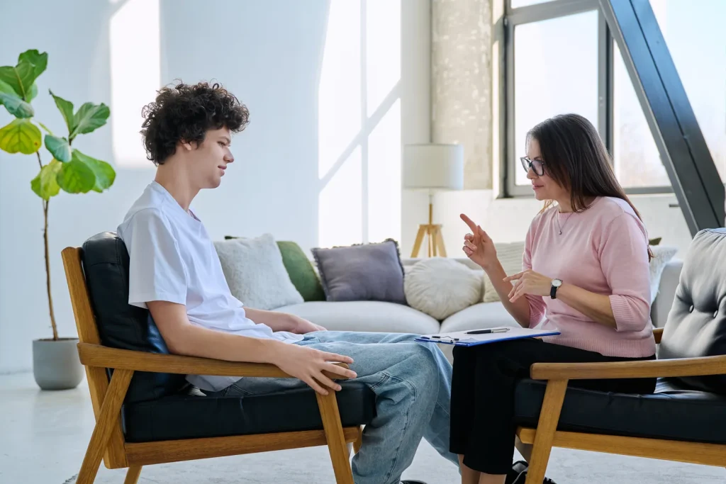 Teen discussing emotions with a therapist in counselling